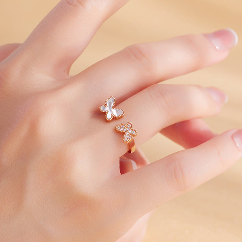 Rose-gold-color butterfly ring styled on hand