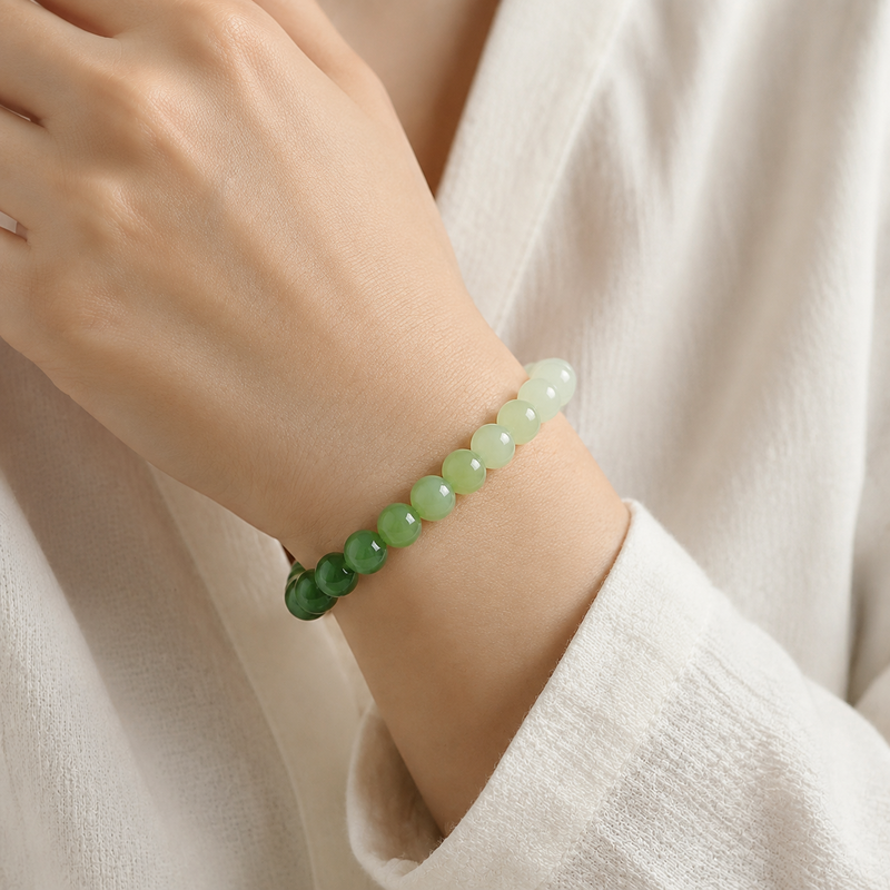 Woman wearing gradient nephrite jade bead bracelet