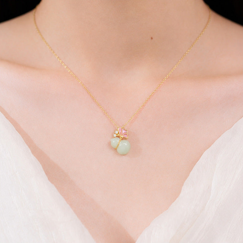 Model wearing a Hetian jade butterfly gourd necklace
