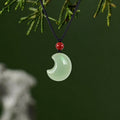 Hetian jade crescent moon necklace with red carnelian on black cord