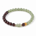 Hetian jade gourd and garnet bracelet on white background