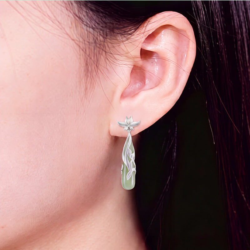 Model wearing one Hetian jade magnolia drop earring