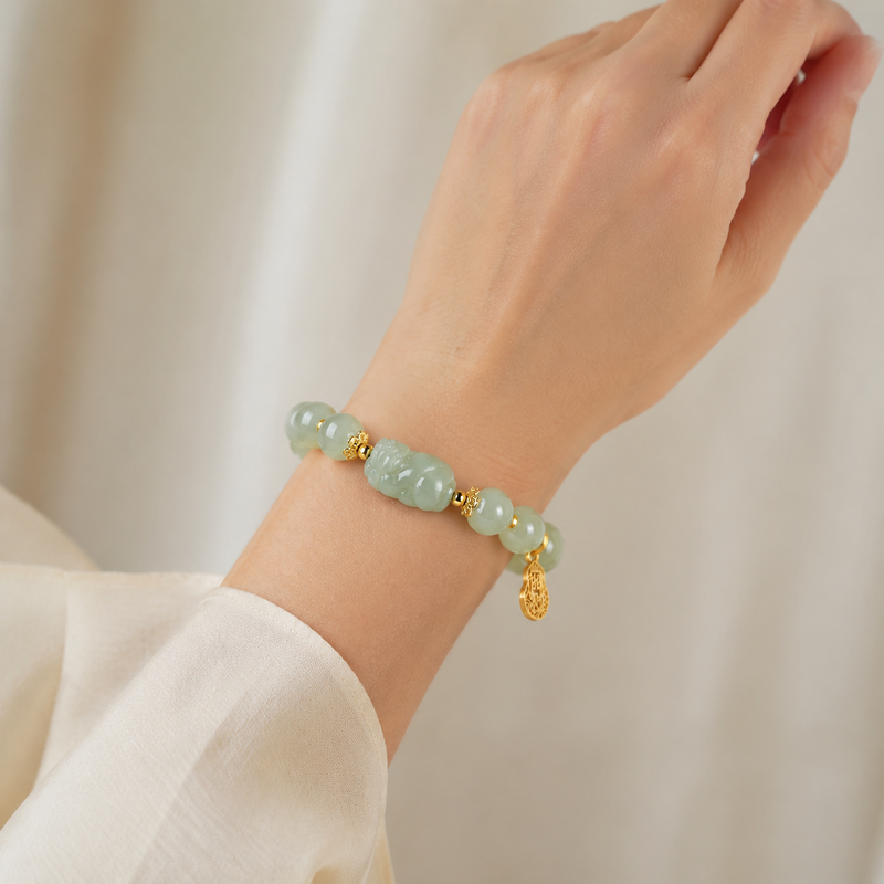 Woman wearing a Hetian jade Pixiu bracelet