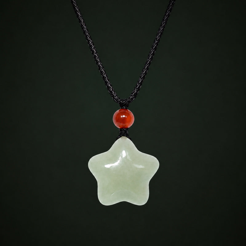 Hetian jade star necklace with red agate on a dark full-background studio setting