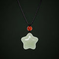 Hetian jade star necklace with red agate on a dark full-background studio setting