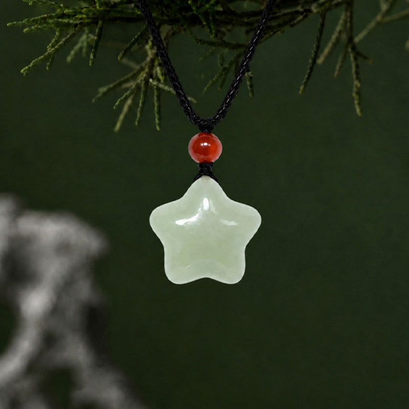 Hetian jade star pendant necklace against a dark green natural background