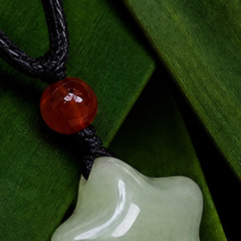 Close view of the red agate bead and black waxed cord