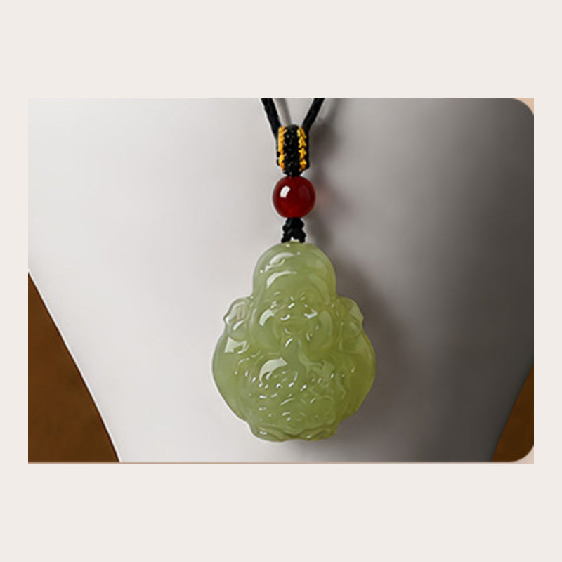 Close-up of the carved Hetian jade Wealth God pendant and red agate bead