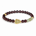 Jadeite gourd and purple garnet bracelet on white background