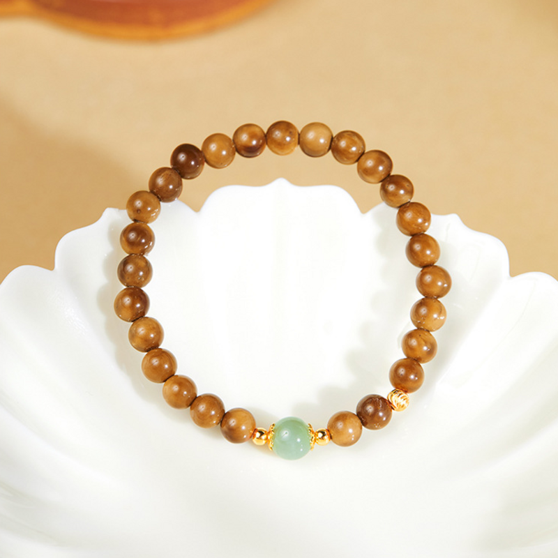 Kuka bead bracelet displayed over a white petal-shaped dish