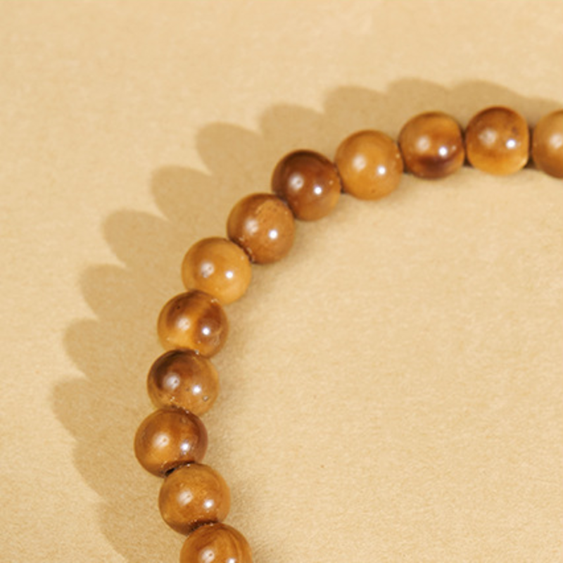 Close detail showing natural grain across polished brown Kuka beads