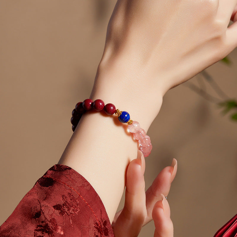 Close wrist view of red pink and blue bead bracelet