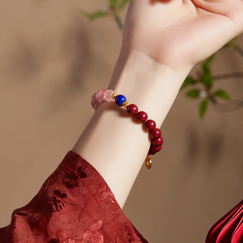Woman wearing lapis lazuli red and pink bead bracelet