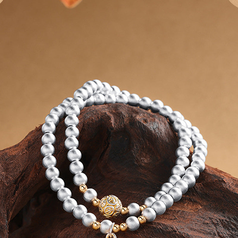 Lion dance double-wrap bracelet arranged on natural wood