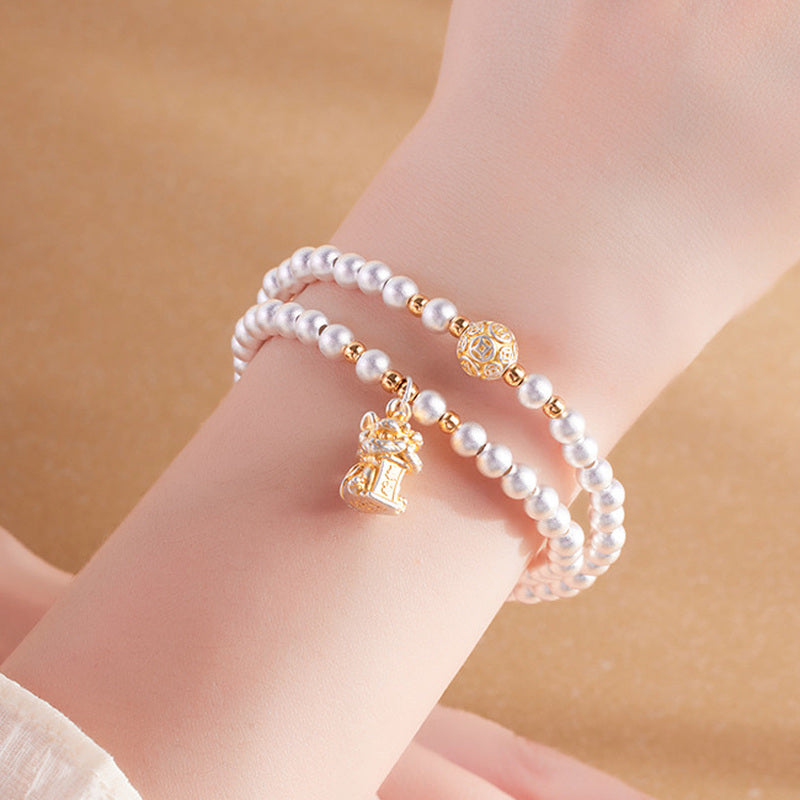 Model wearing the 999 fine silver lion dance double-wrap bracelet