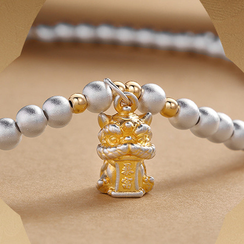 Close view of the lion dance pendant and silver beads