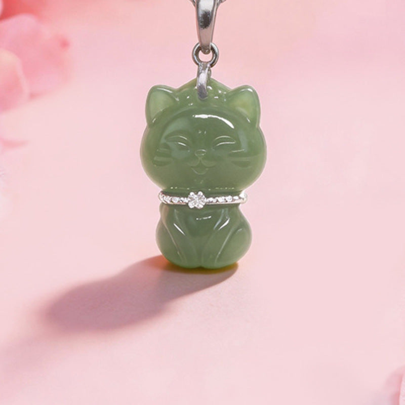 Close view of carved nephrite jade lucky cat pendant