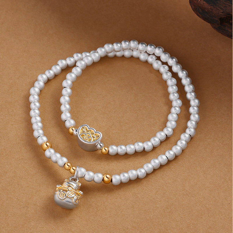 999 fine silver lucky cat double-wrap bracelet on warm sand