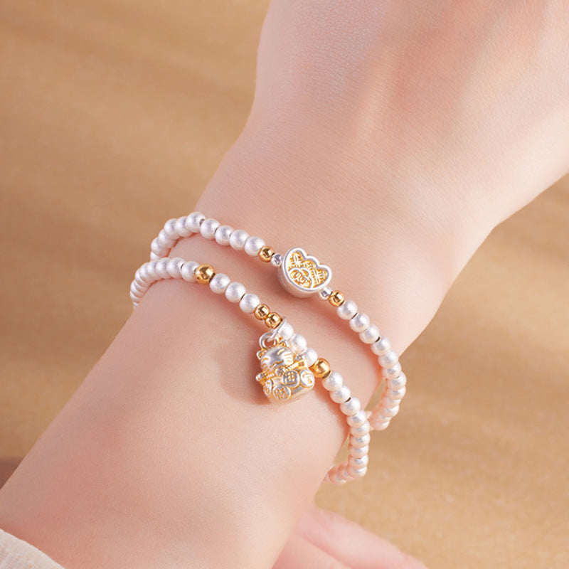 Close model view of double-wrap silver lucky cat bracelet