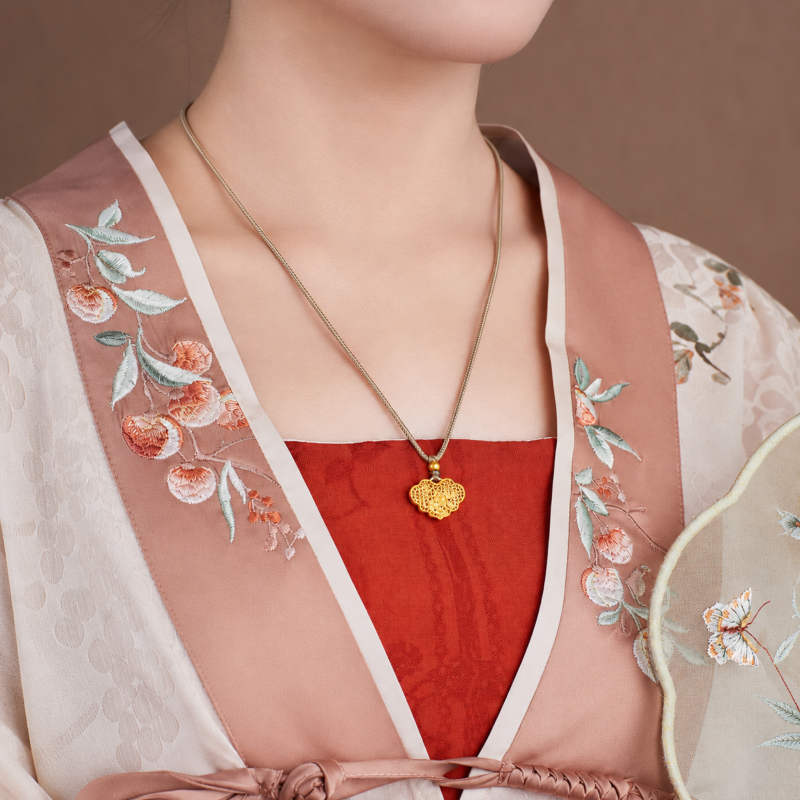 Supplier model wearing the lock necklace beside a fan