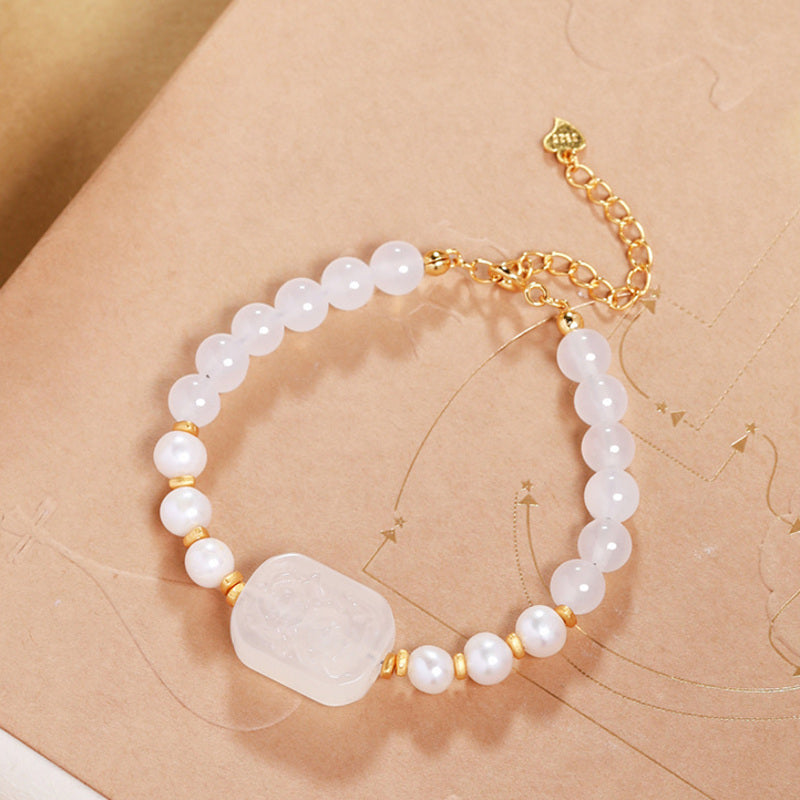 Adjustable white chalcedony and pearl bracelet flat lay