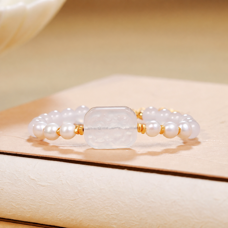 White chalcedony and freshwater pearl bracelet on warm ivory display