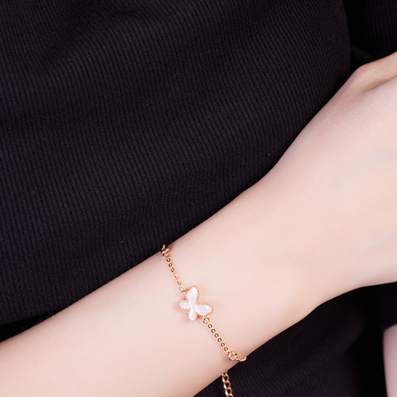 Delicate mother-of-pearl butterfly bracelet worn on a woman's wrist