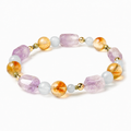 Multi-gemstone crystal bracelet with citrine, amethyst, aquamarine and green crystal beads on white