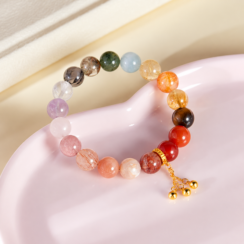 Multicolor crystal and agate bracelet on a pink ceramic dish
