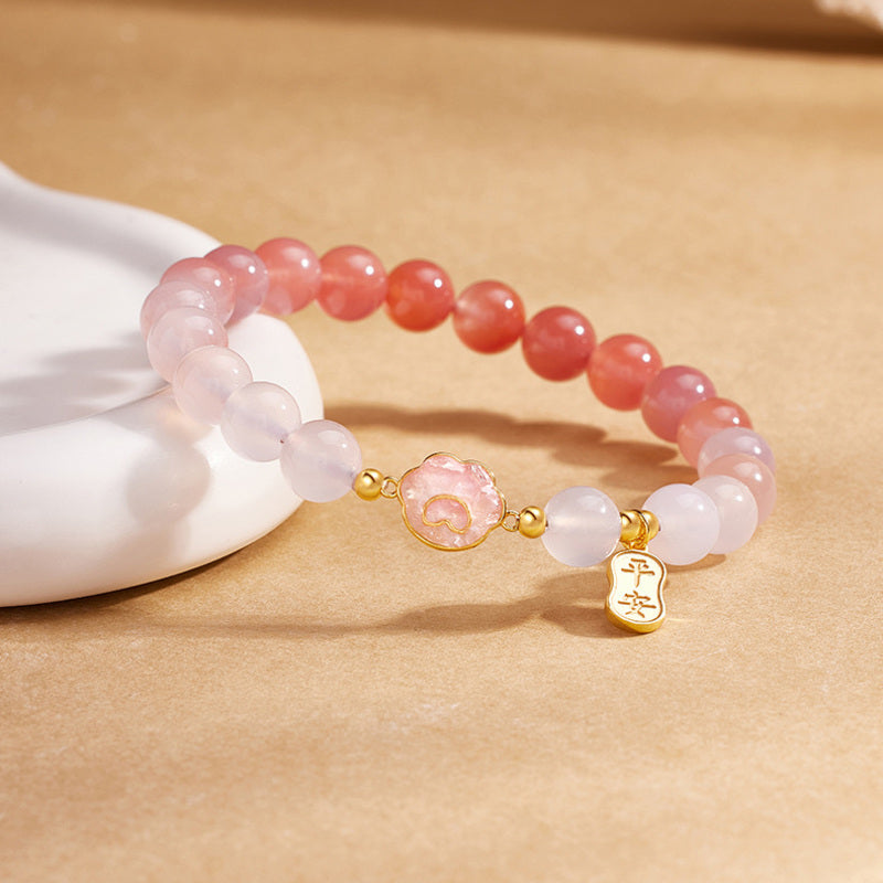 Crimson agate cat paw bracelet showing polished bead gradient