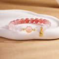 Natural crimson agate cat paw bracelet on warm sculpted display