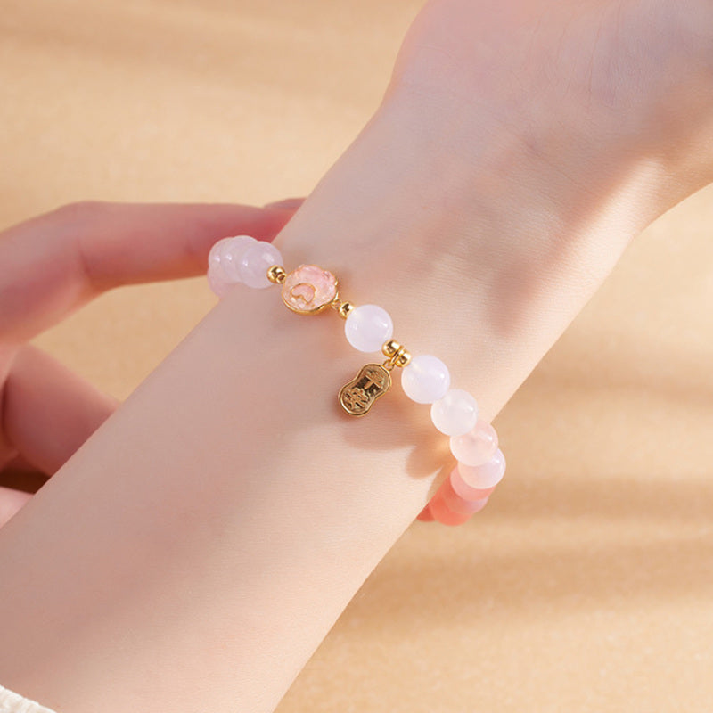 Crimson agate cat paw bracelet worn on a slender wrist