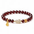 Nephrite jade gourd garnet bracelet on a white background
