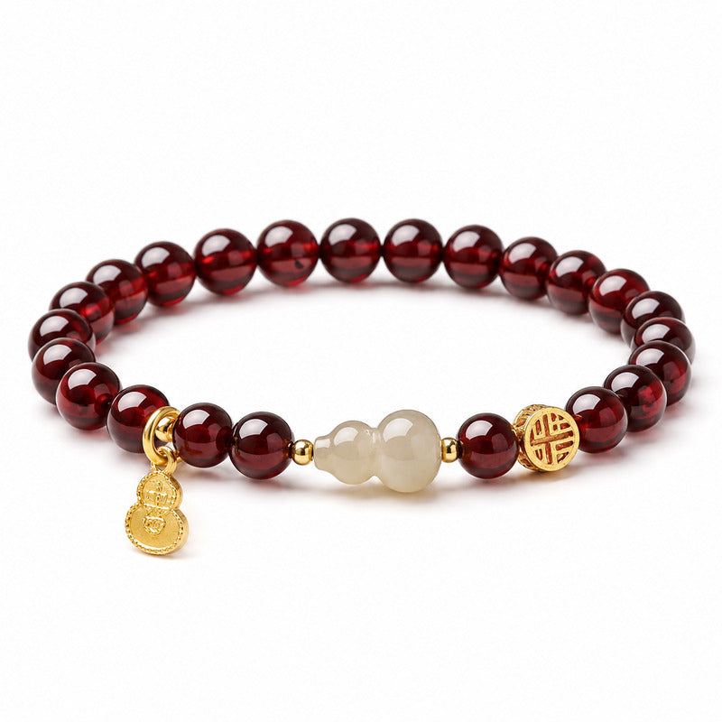 Nephrite jade gourd garnet bracelet on a white background