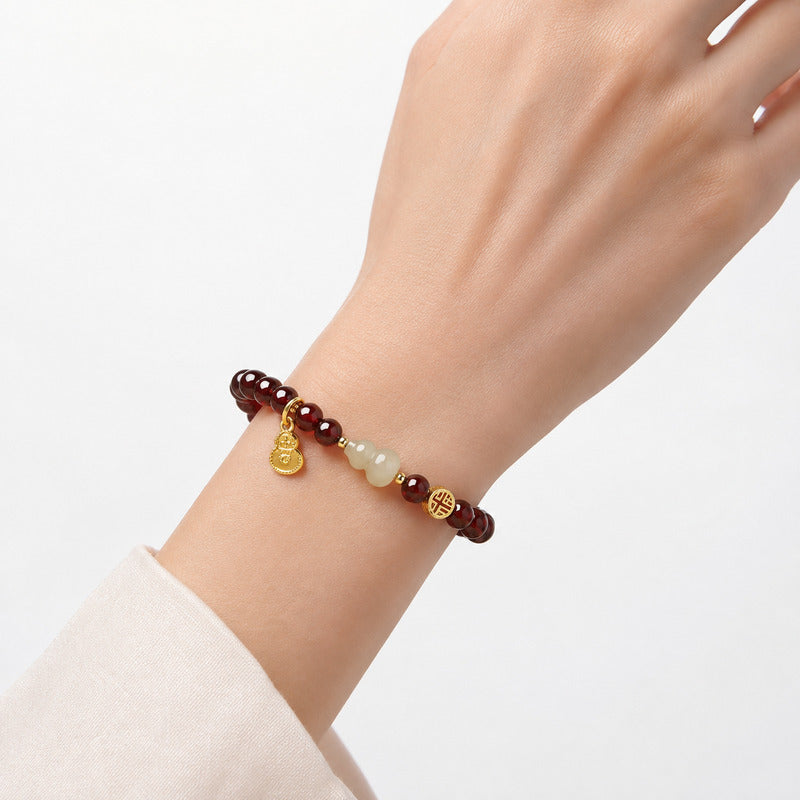 Woman wearing the 8 mm garnet and nephrite jade gourd bracelet
