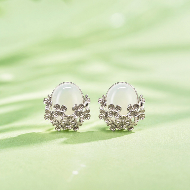 Pair of nephrite jade flower stud earrings in soft green setting
