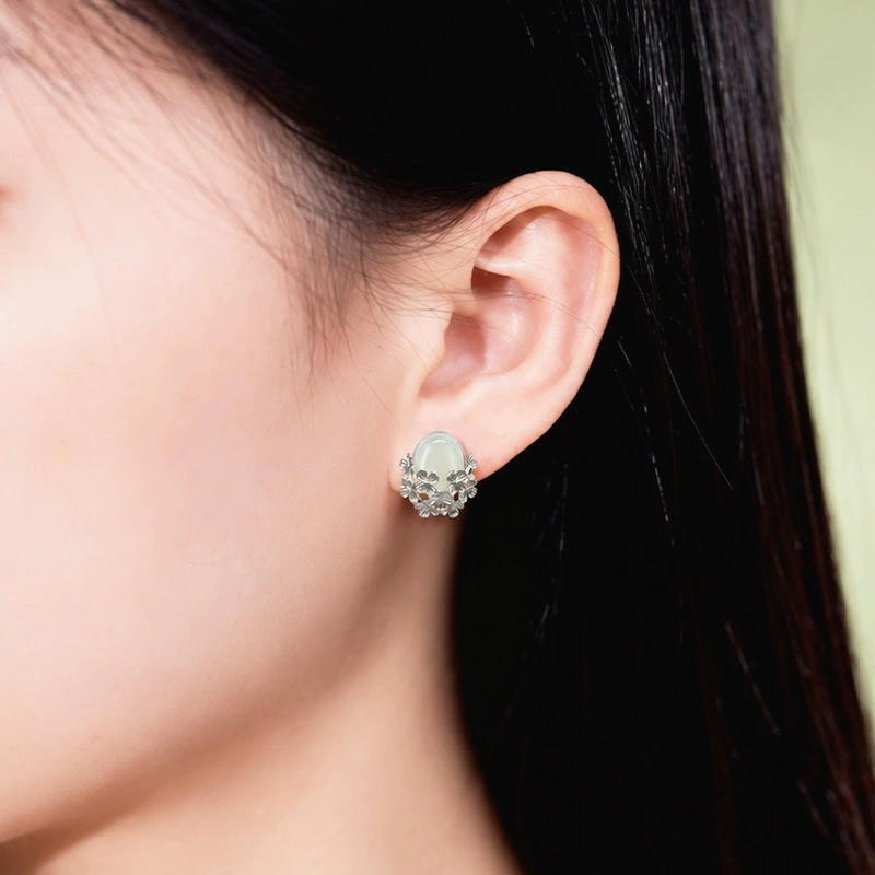 Nephrite jade flower stud earring worn on model