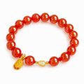 Nephrite jade gourd and red agate bracelet on white background