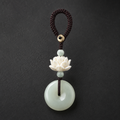 Nephrite jade lotus keychain on dark slate background