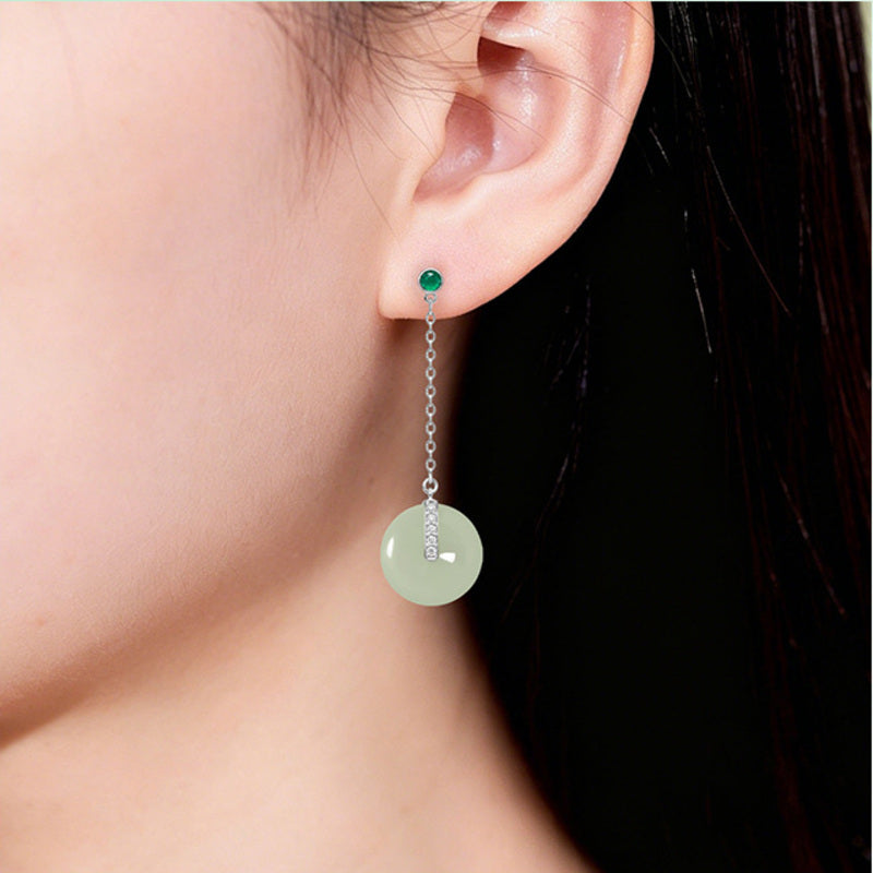 Model wearing nephrite jade peace buckle drop earrings