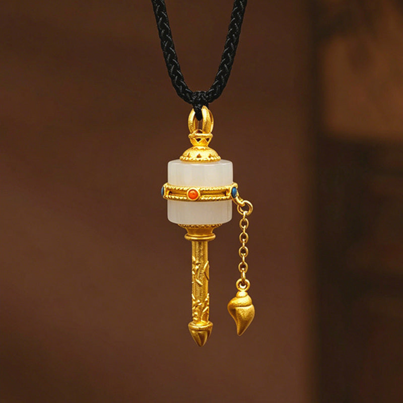 Nephrite Jade prayer wheel pendant on warm brown background