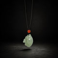 Nephrite Jade zodiac rabbit pendant on a dark studio background