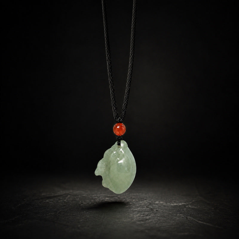 Nephrite Jade zodiac rabbit pendant on a dark studio background