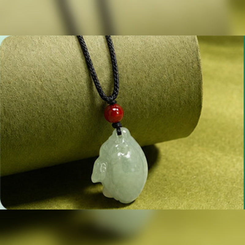 Carved rabbit detail with red agate and black cord