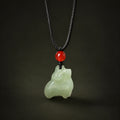 Nephrite jade Zodiac Sheep pendant on a dark background