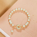 Nephrite jade peace buckle bracelet with bamboo beads on a peach background
