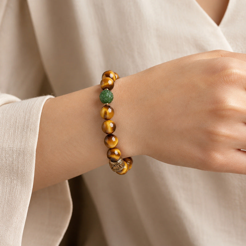 Woman wearing nephrite jade Pixiu yellow Tiger's Eye bracelet