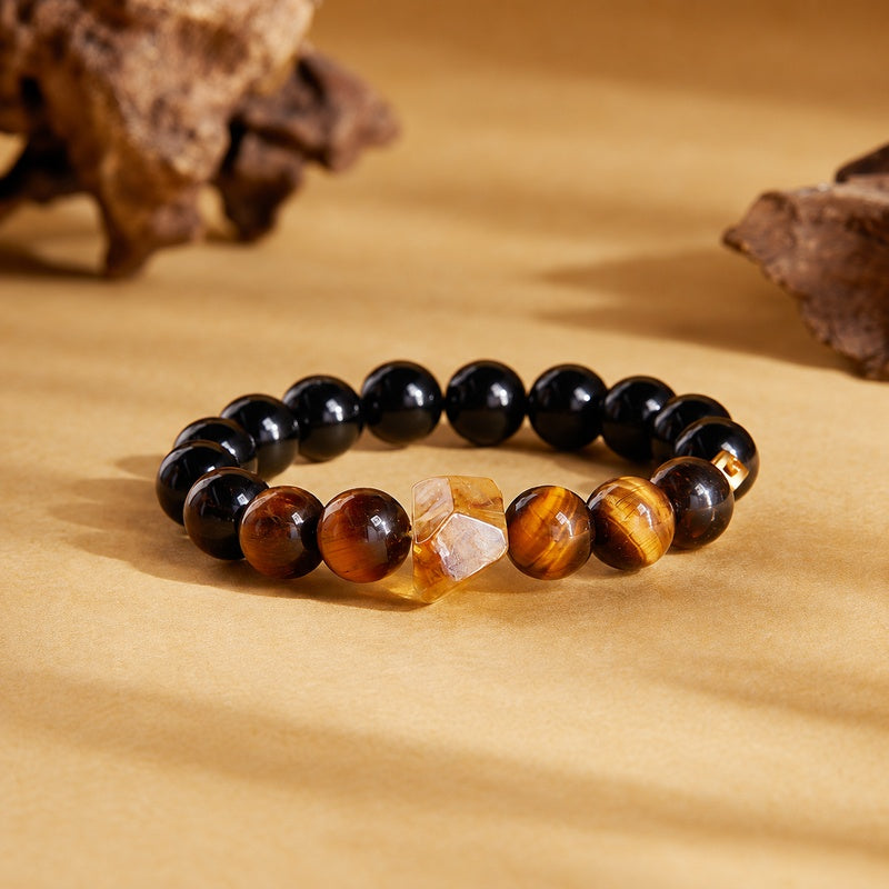 Black obsidian and tiger eye bracelet on a warm golden background