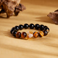 Black obsidian and tiger eye bracelet on a warm golden background