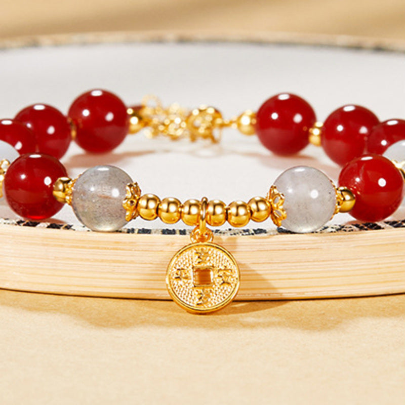Round peace coin charm with red agate and gray moonstone details